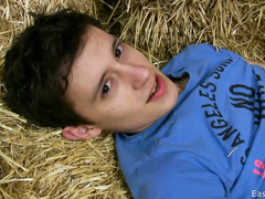 Innocent looking teen twink is undressing and wanking off on hayloft